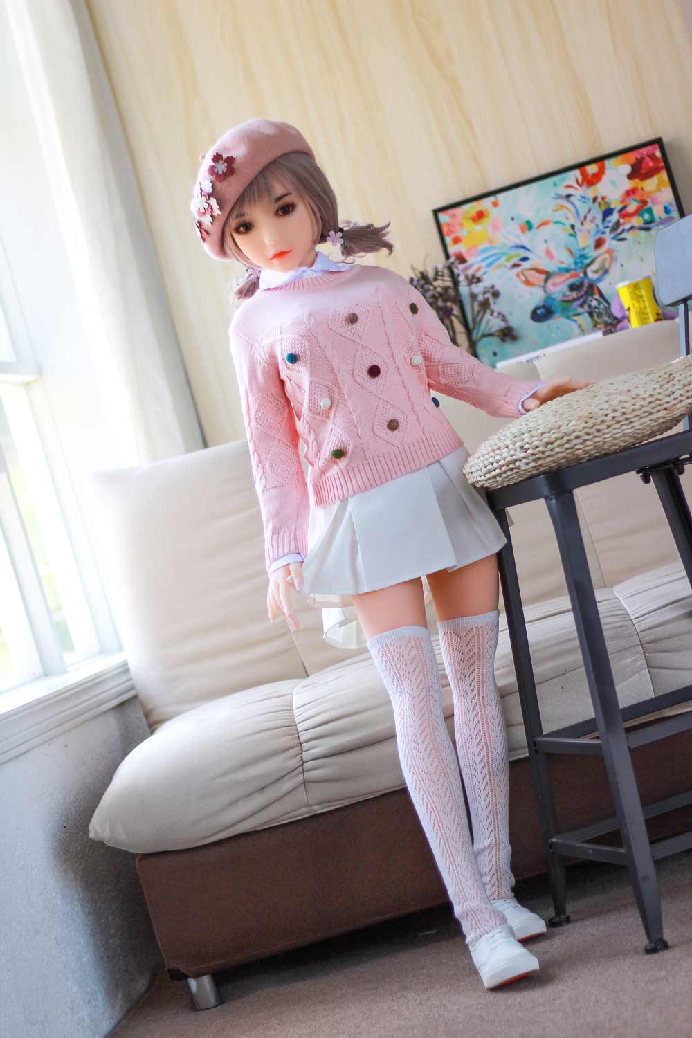 A mini sex doll standing with a hand drawn skirt corner