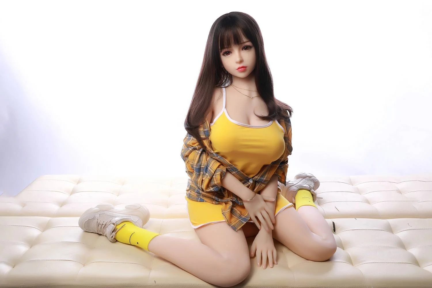 A sex doll sitting on knees with legs apart