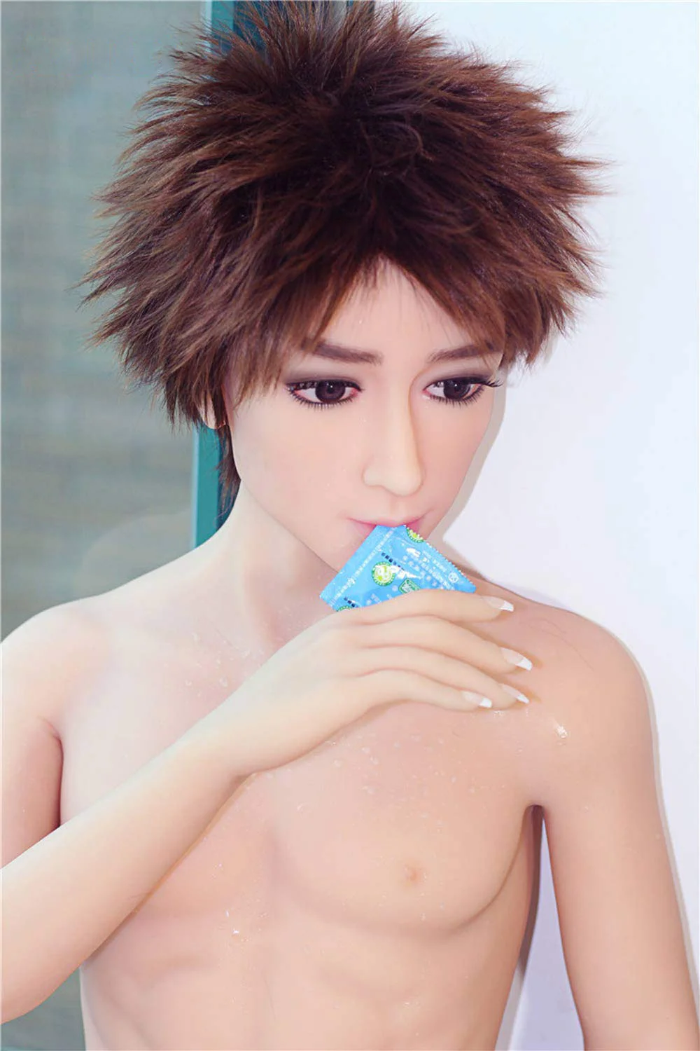 Male-sex-doll-with-condom-in-his-mouth