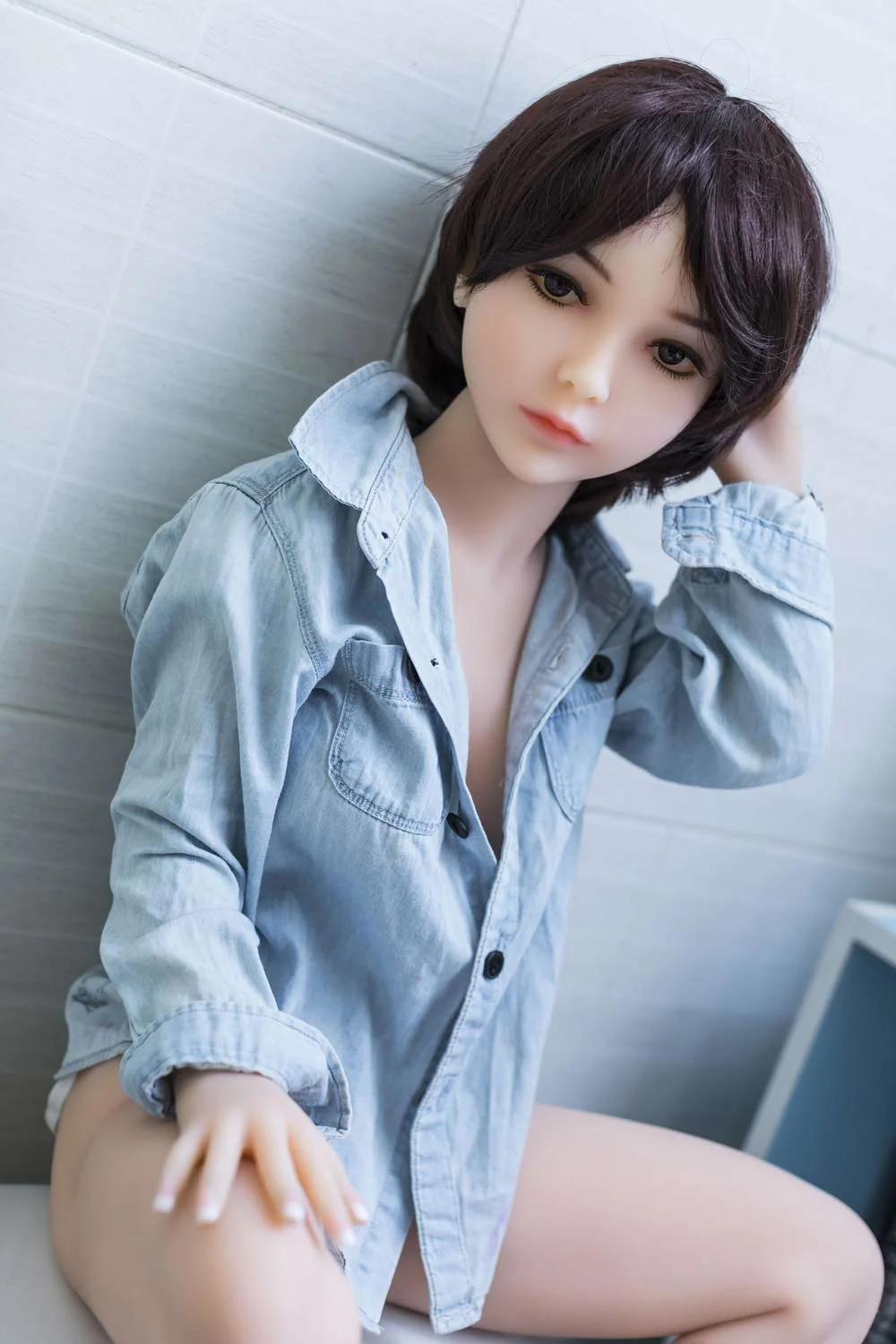 Mini sex doll with hand on thigh