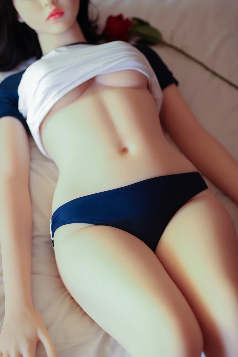 Sex doll lying flat on the ground
