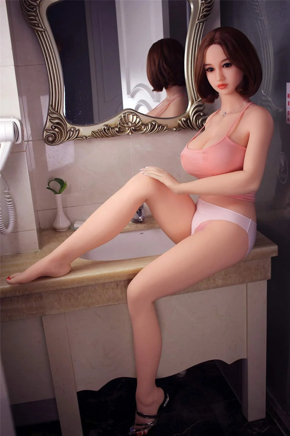 Sex doll sitting on the sink and touching thigh