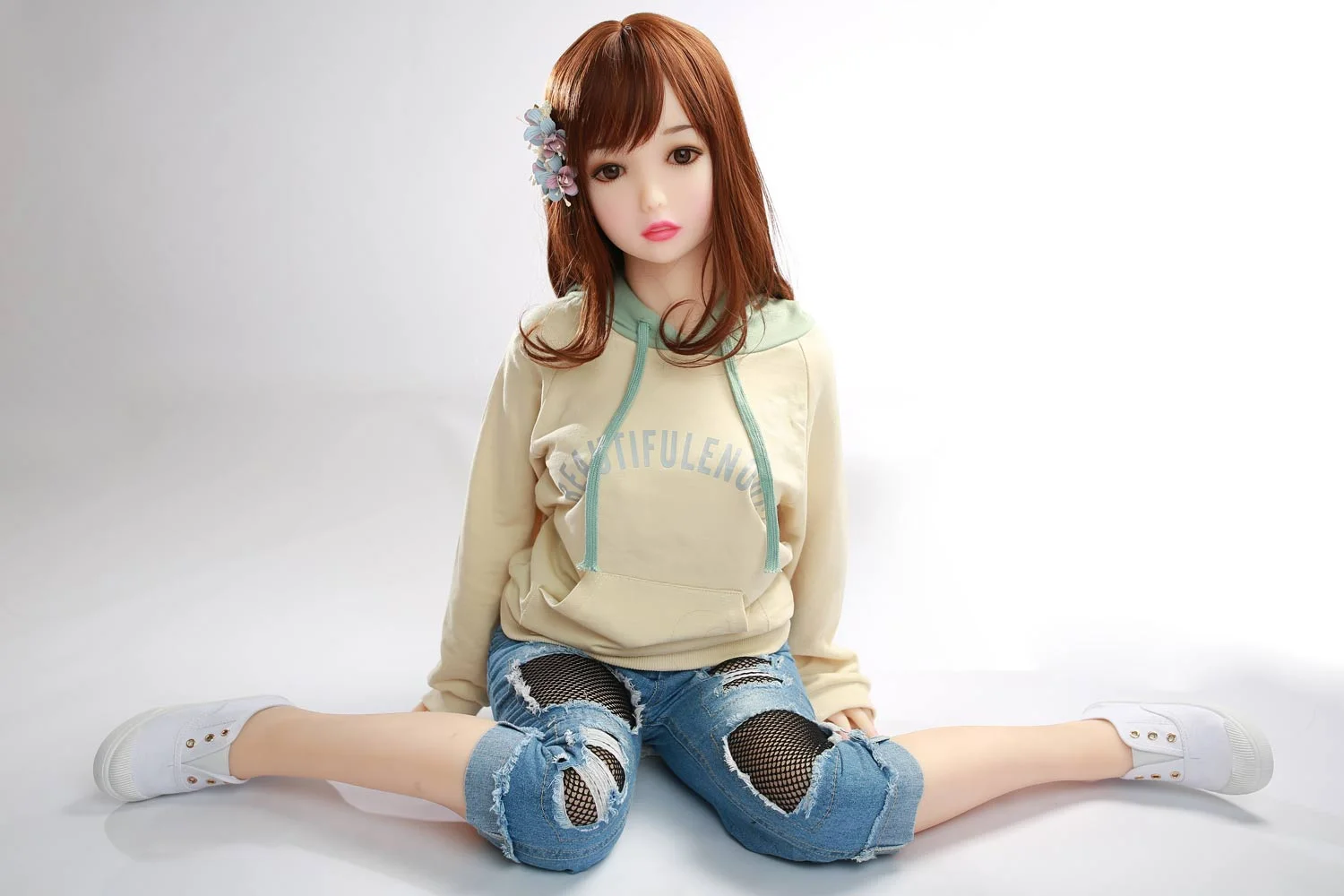 Sex doll sitting with legs apart
