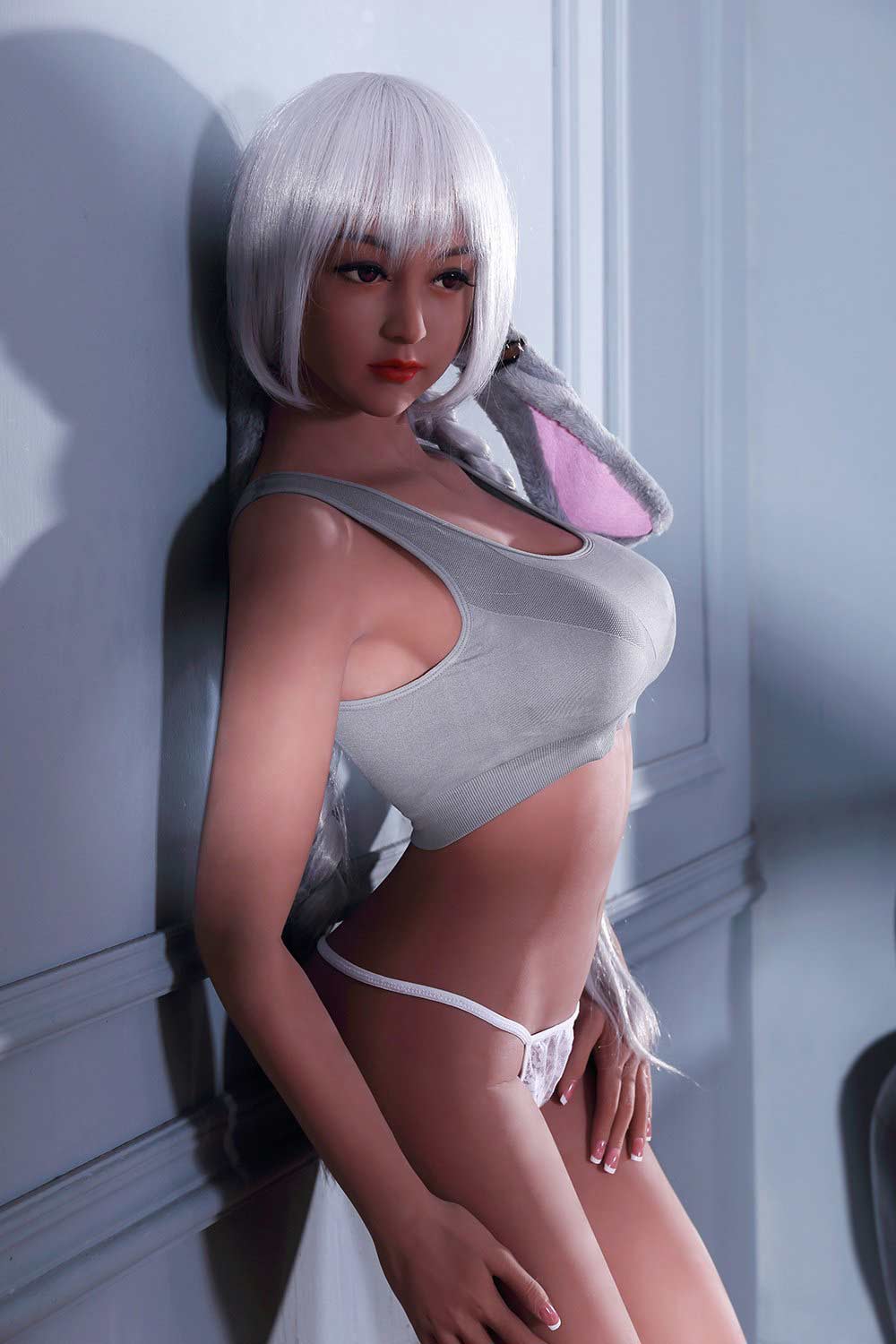 Sex doll with back against the wall