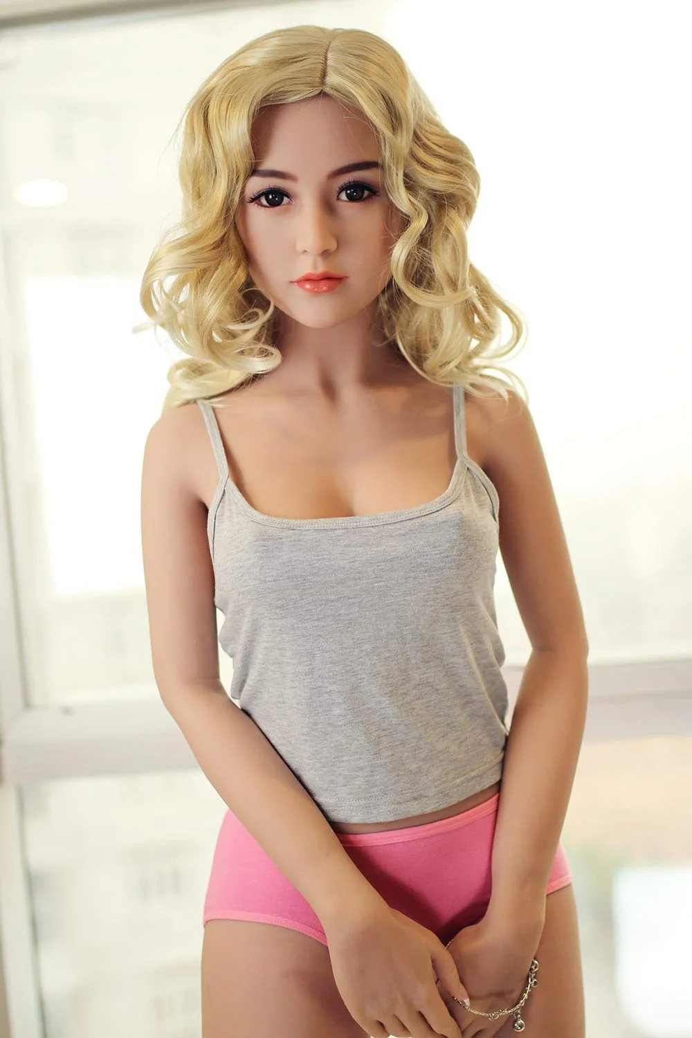 Sex doll with hands between thighs