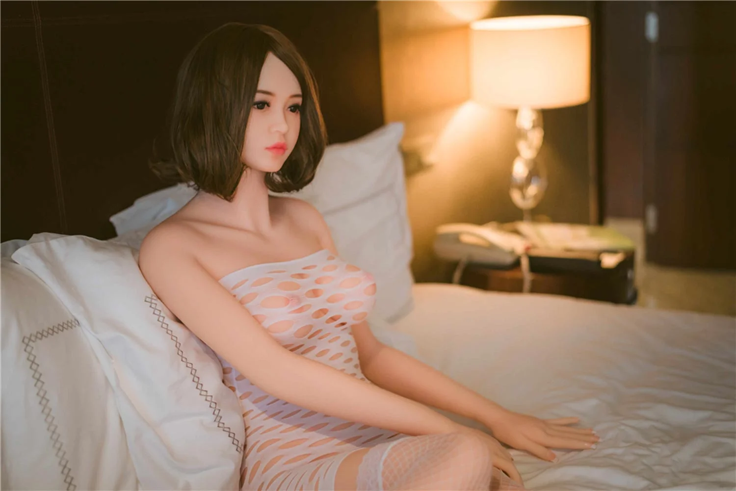 Sex doll with hands on bed