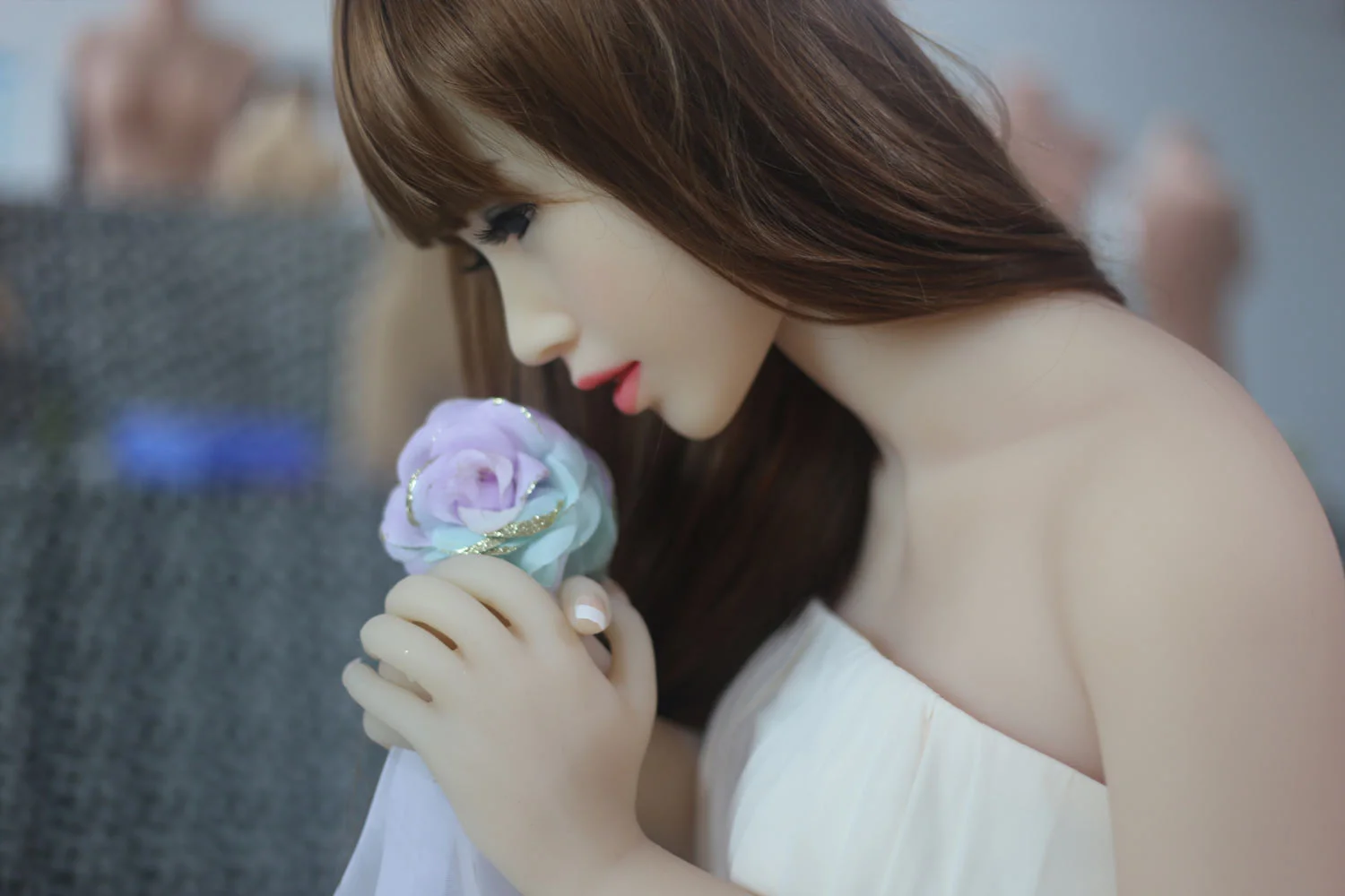 Sex doll with nose sniffing flowers