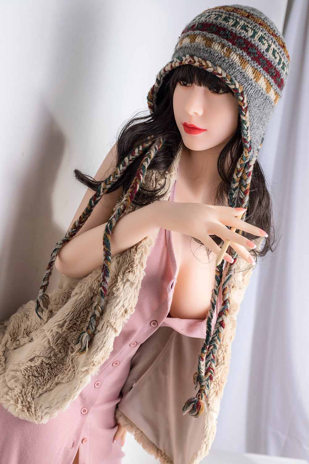 Sex doll with pen between fingers