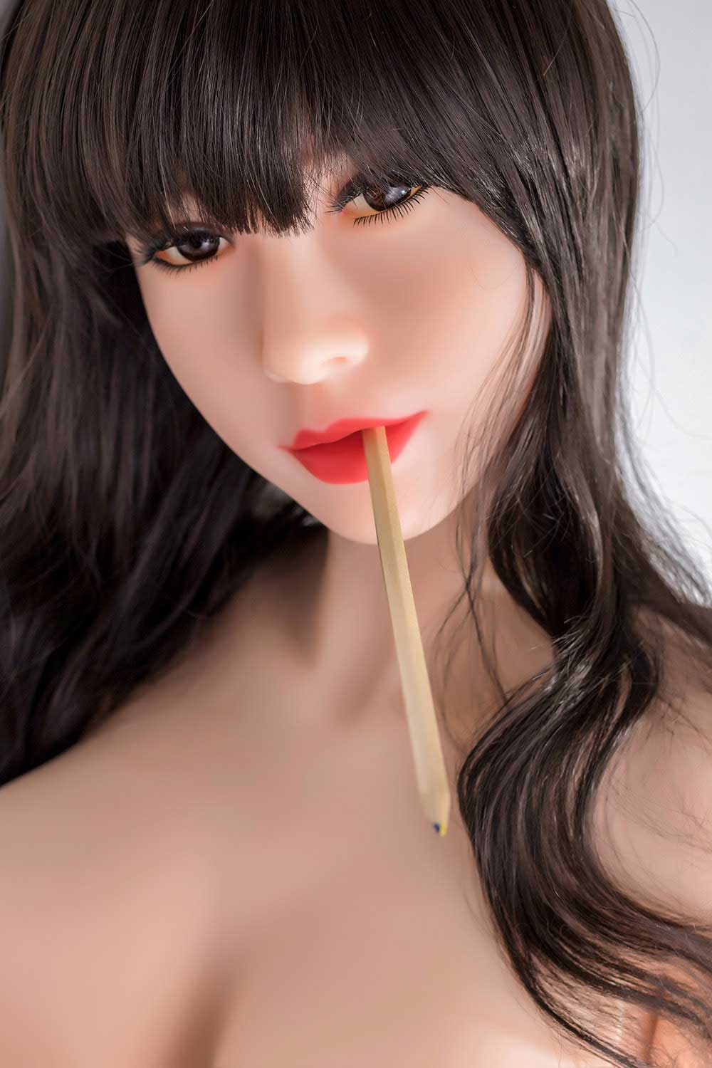 Sex doll with pen in mouth