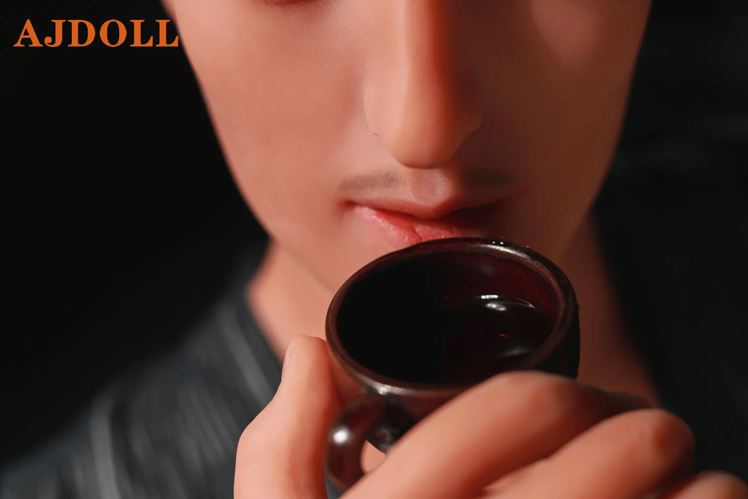 Male sex doll holding tea cup in hand