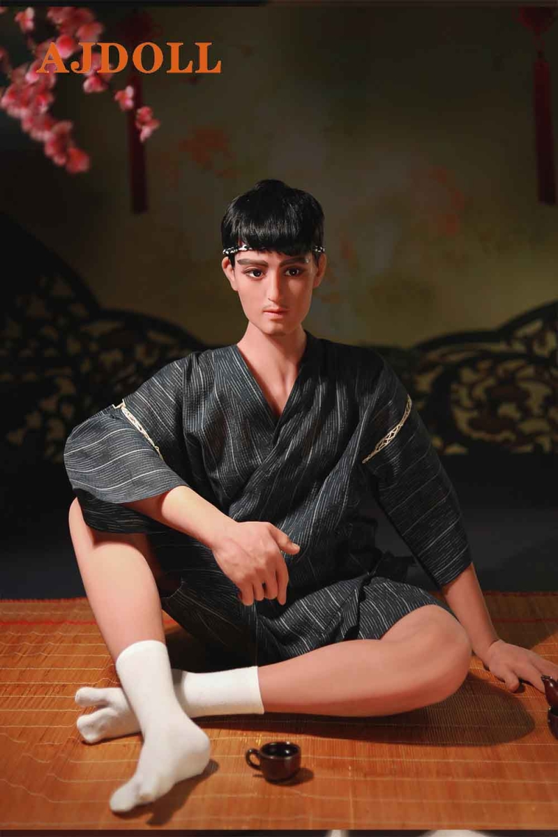 Male sex doll sitting on the mat