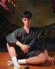 Male sex doll sitting on the mat