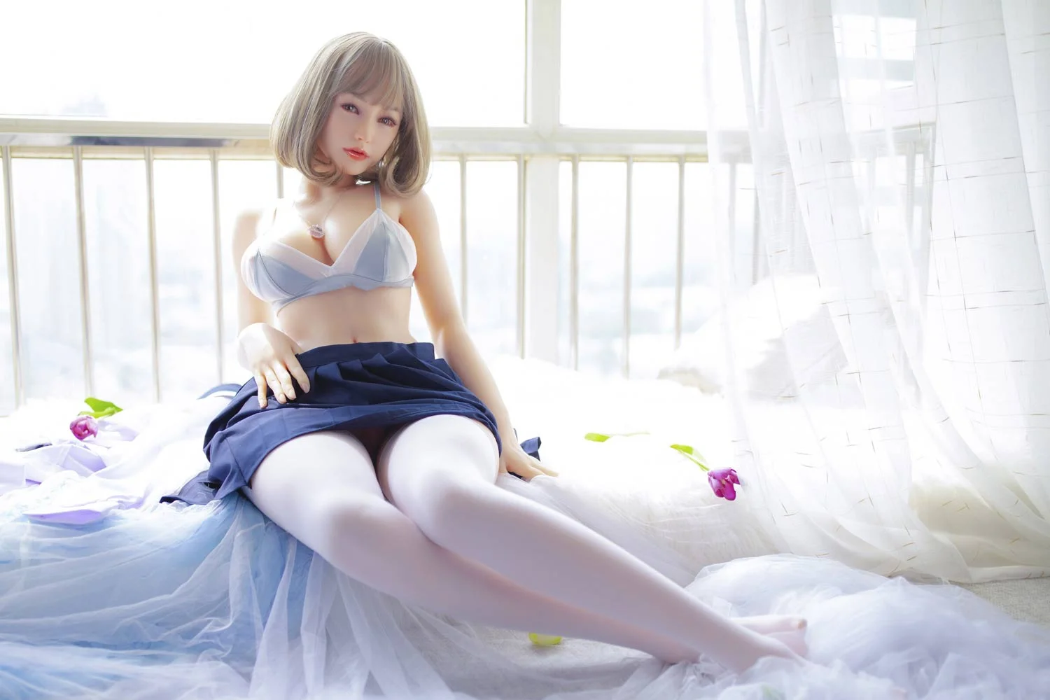 Sex doll in white stockings sitting on the windowsill