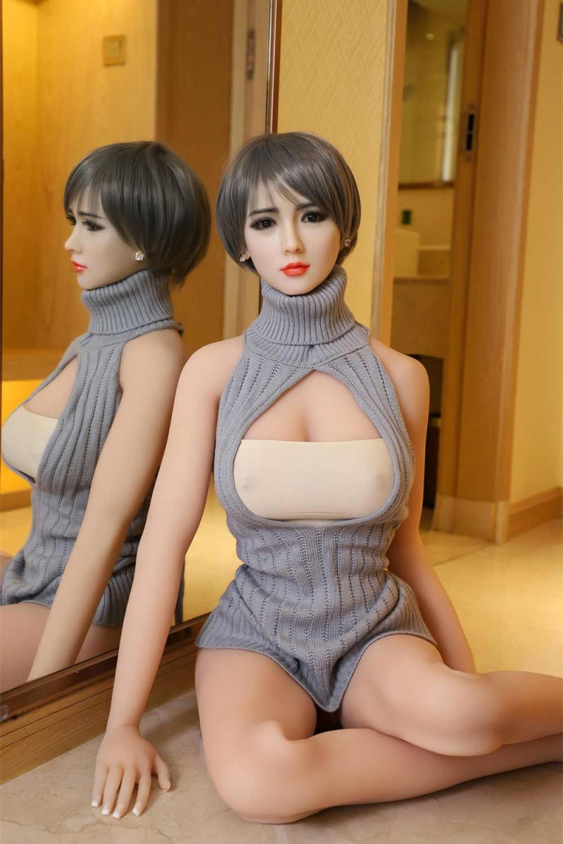 Silicone sex doll sitting on the ground