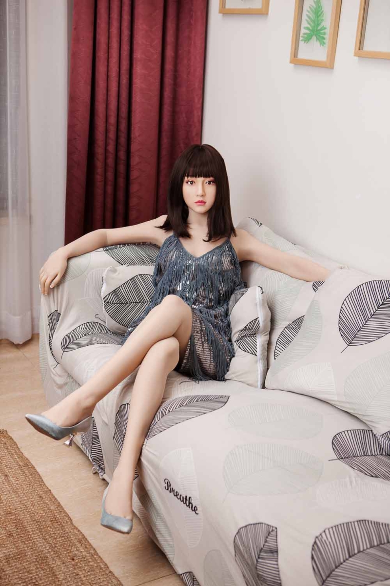 Silicone sex doll sitting on the sofa