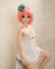 A mini sex doll with short pink hair in a white dress