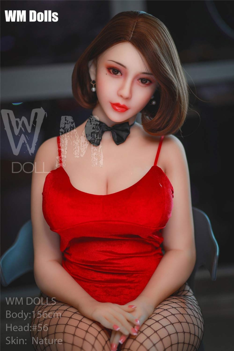 Big breasted sex doll sitting on a chair
