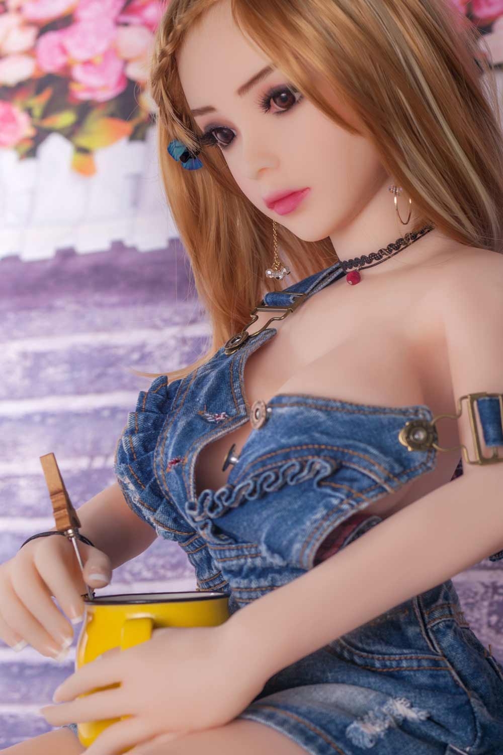 Mini sex doll holding a cup in both hands