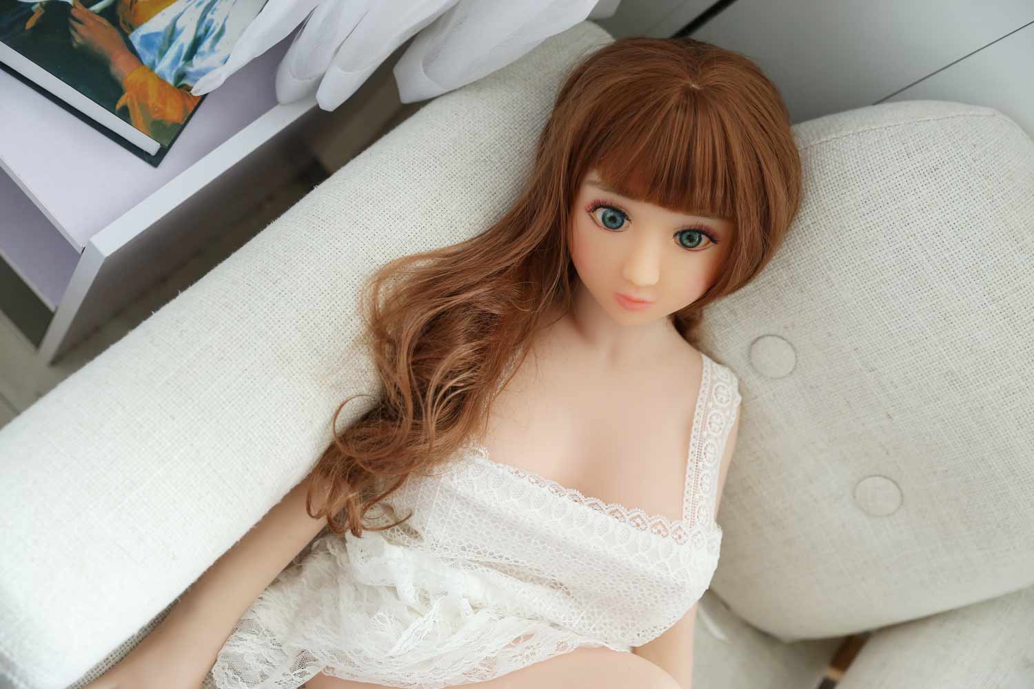 Mini sex doll leaning on the sofa