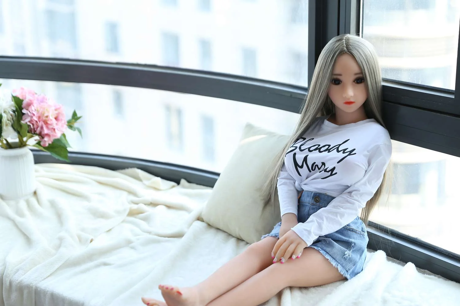 Mini sex doll leaning on the window