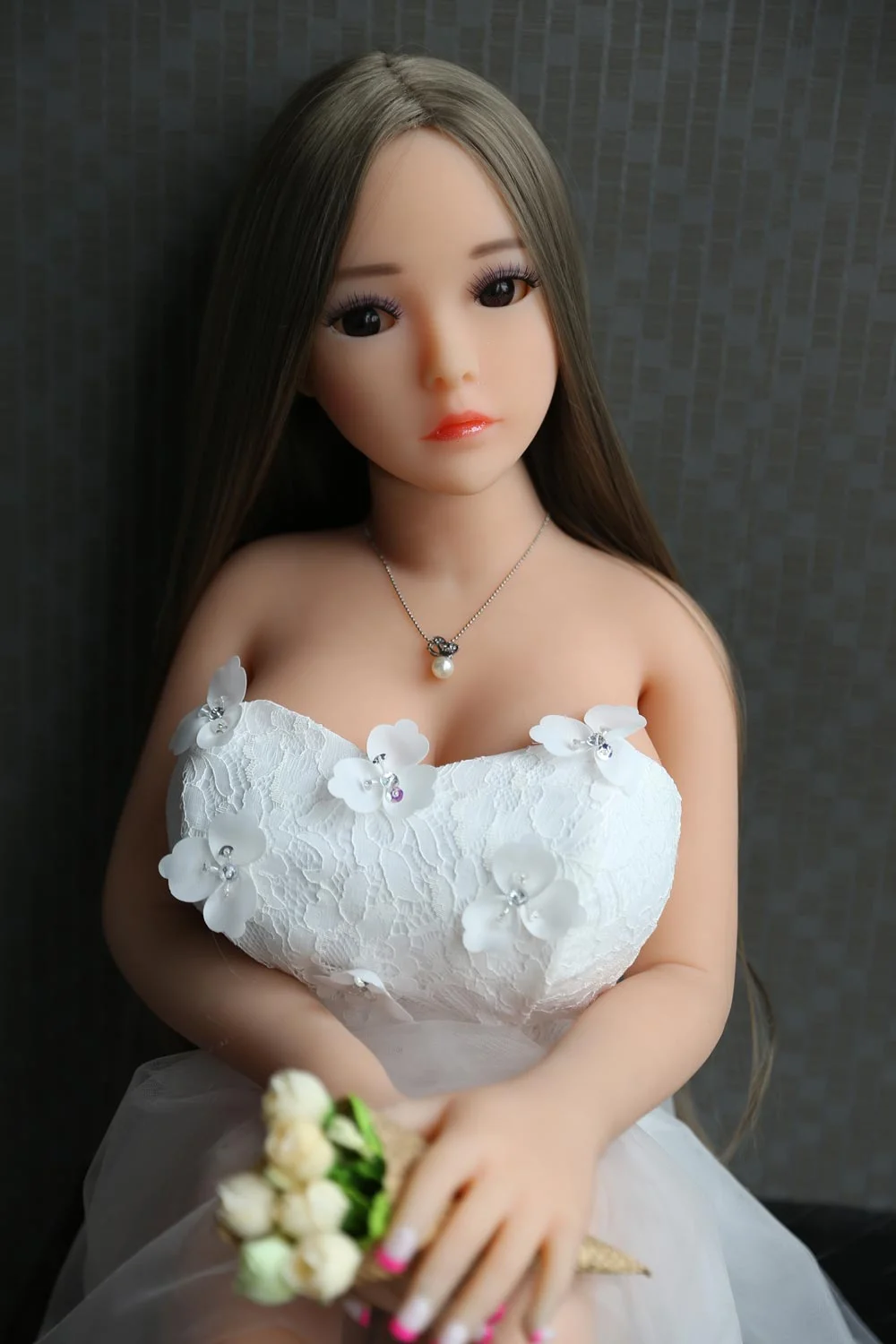 Mini sex doll with flowers in both hands