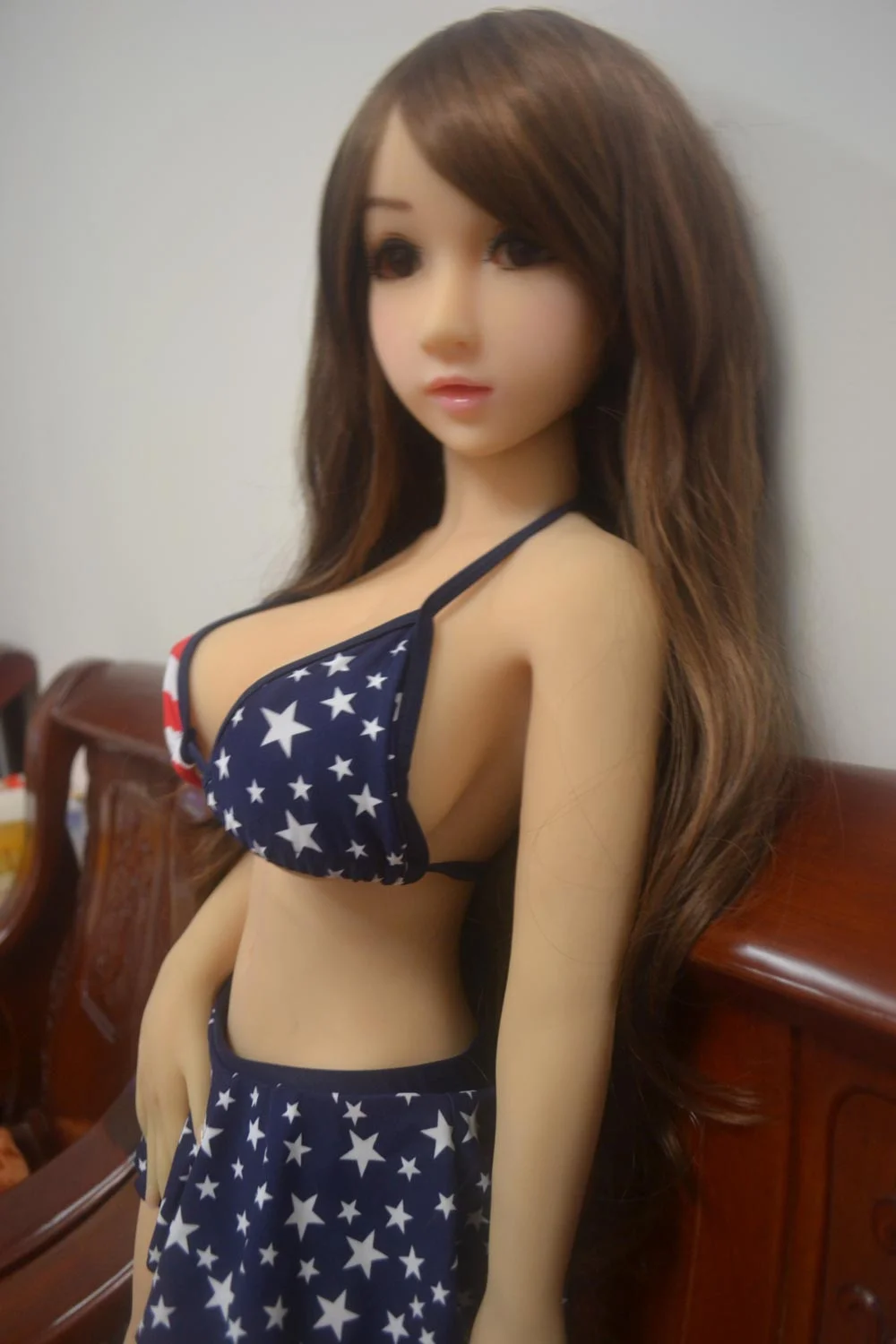 Mini sex doll with hands on skirt