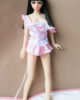 Mini sex doll with long black hair in a pink dress