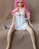 Mini sex doll with pink long hair and hands on legs