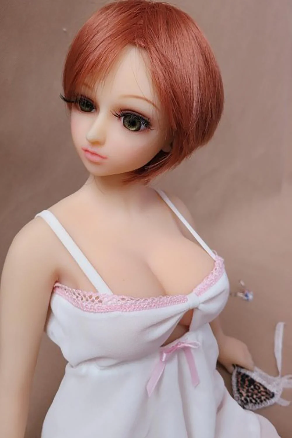 Mini sex doll with short brown hair and big eyes