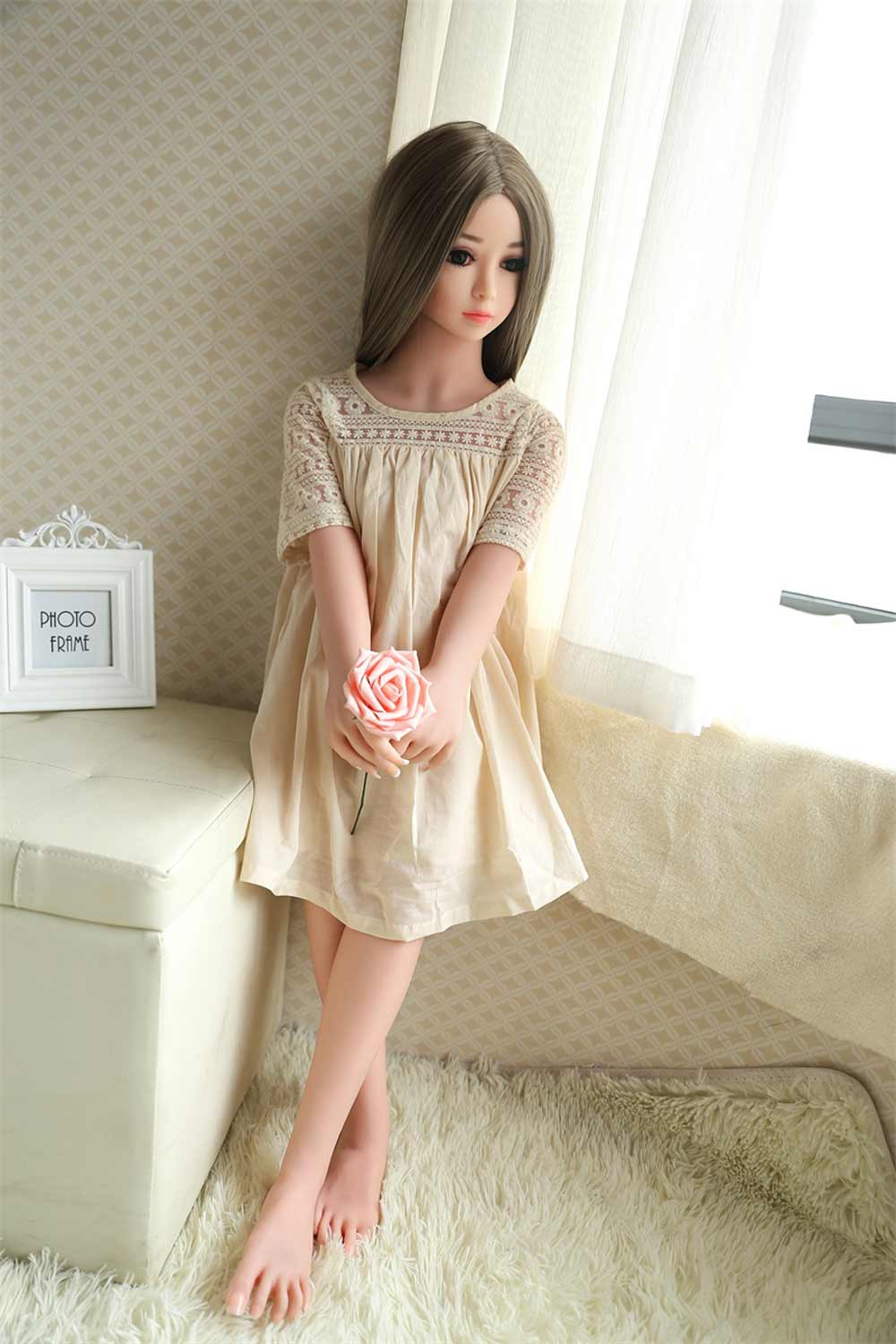 Mini sex doll holding roses in both hands