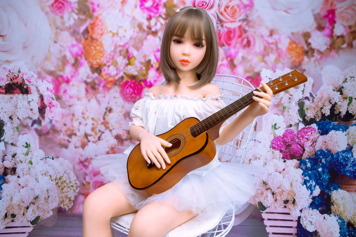 Mini sex doll playing the guitar