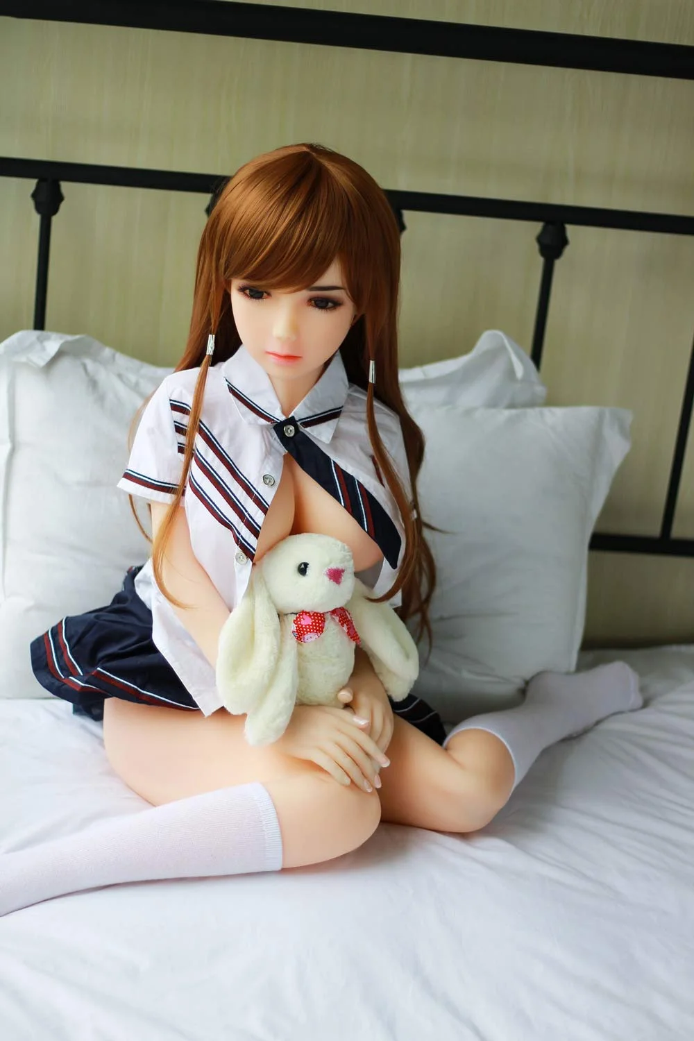 Mini sex doll sitting with legs crossed