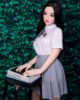 Mini sex doll with a book on a stool