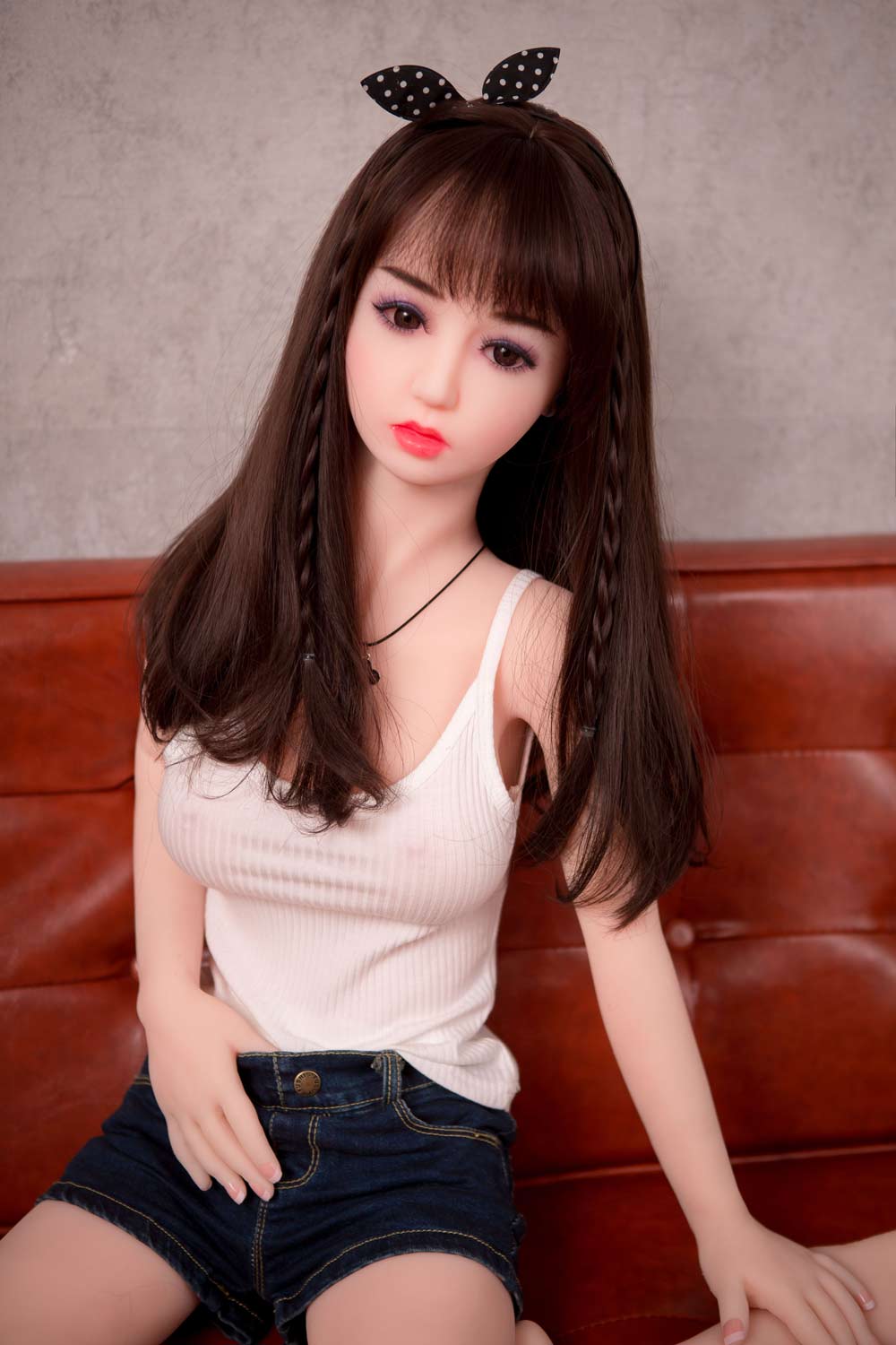 Mini sex doll with hands in denim shorts
