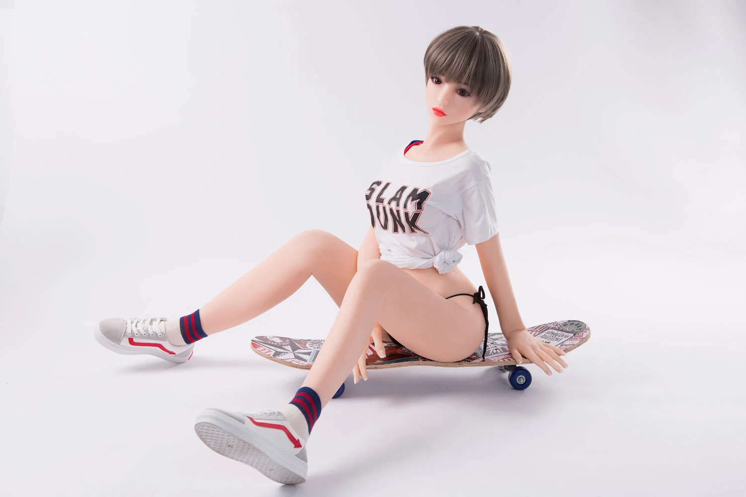 Mini sex doll with hands on skateboard