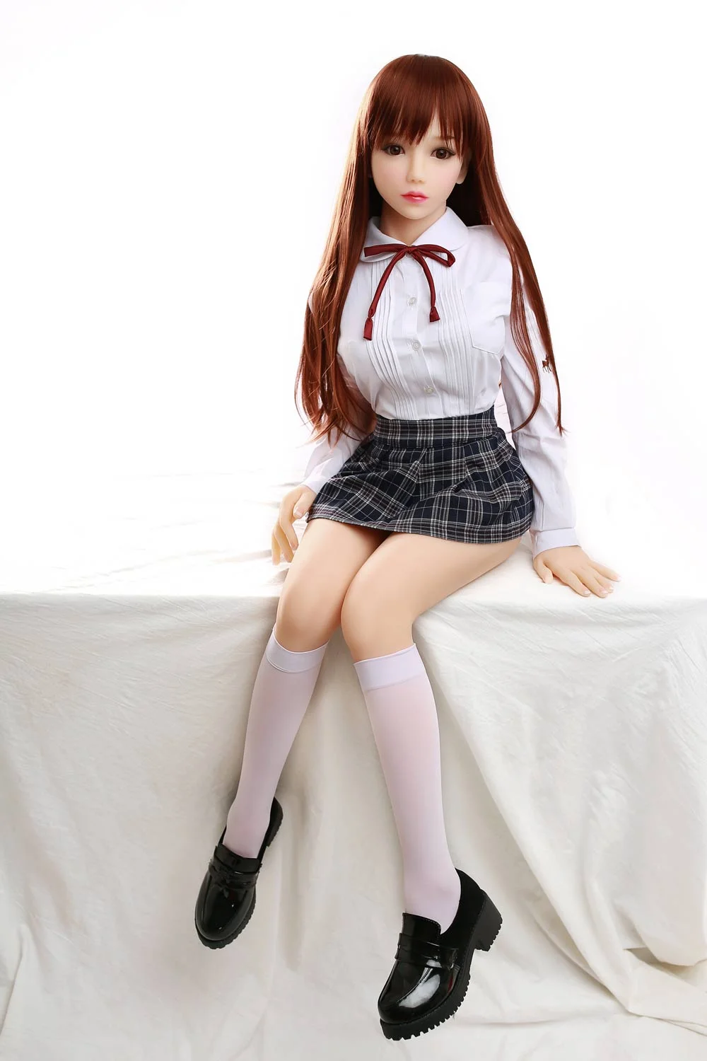 Mini sex doll with hands on the table