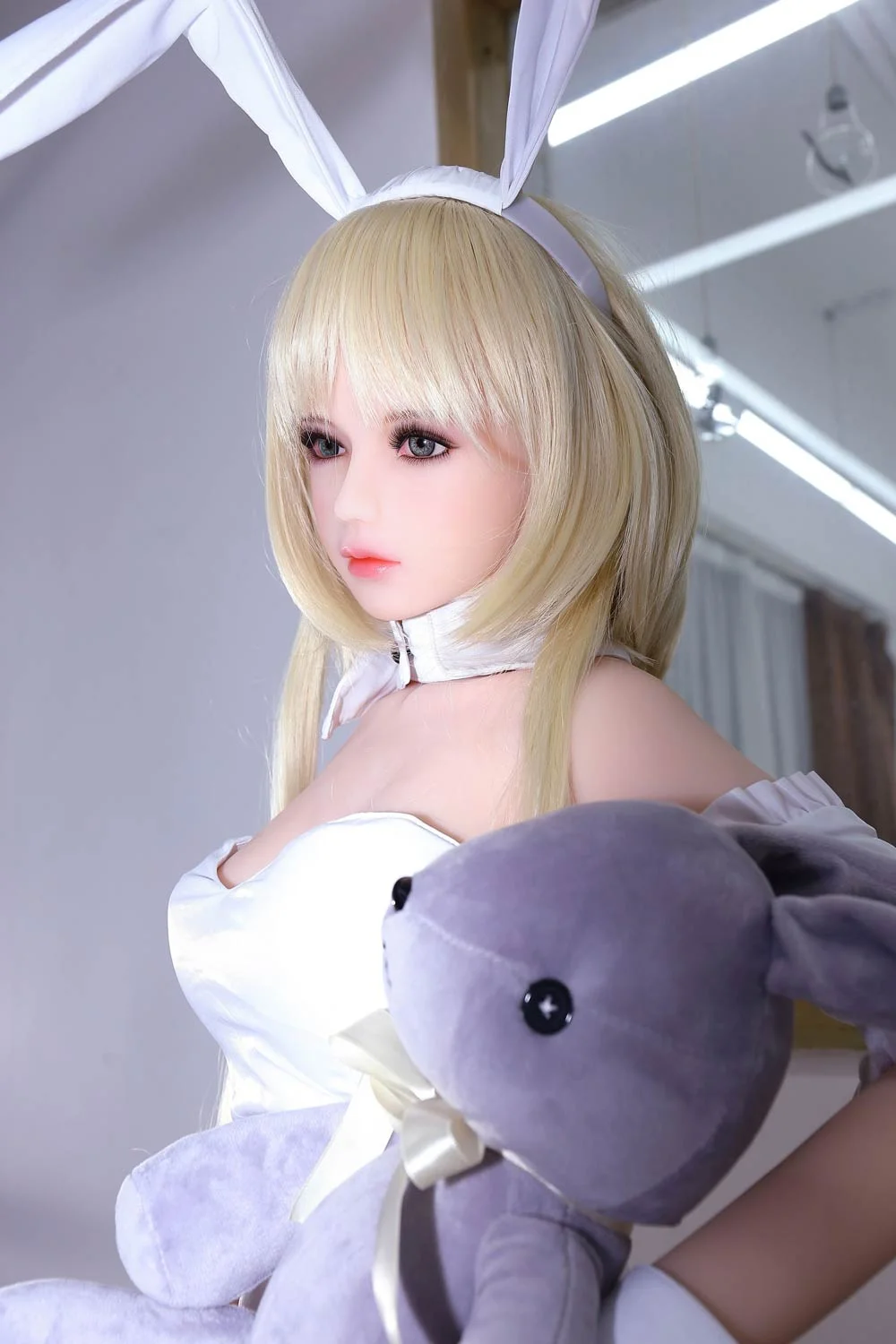 Mini sex doll with purple toy in hand