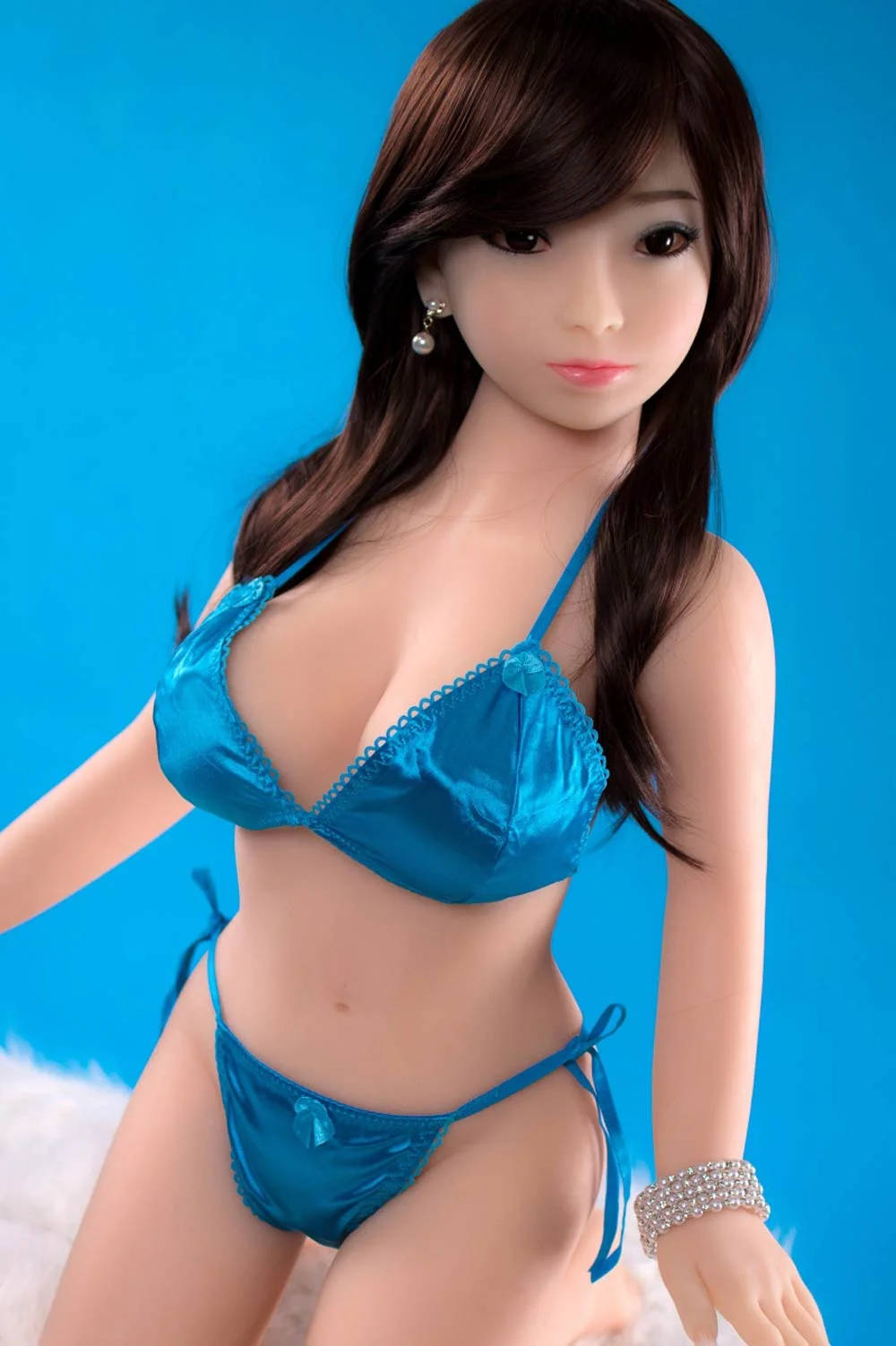 Sex doll with pearl necklace in hand