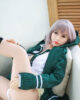 An anime sex doll with one leg raised and hands on it