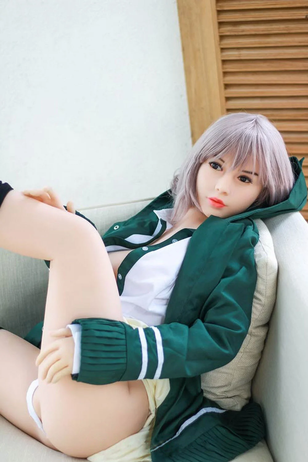 An anime sex doll with one leg raised and hands on it