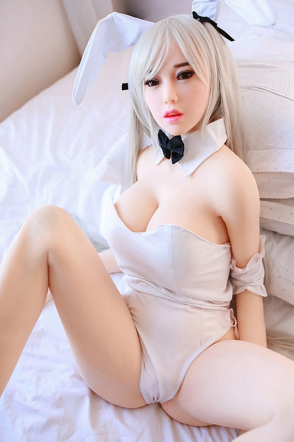 Anime sex doll lying on the bed with spread legs