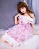 Anime sex doll with legs kneeling on the bed and hands on top