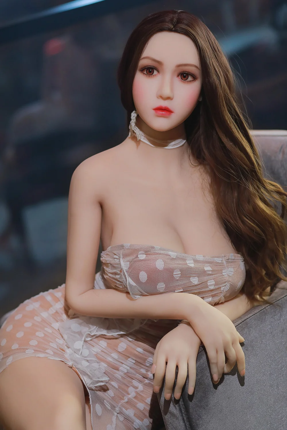 Sex doll sitting on a chair with hands on the armrests