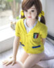 A mini sex doll kneeling on the ground with hands on her ass
