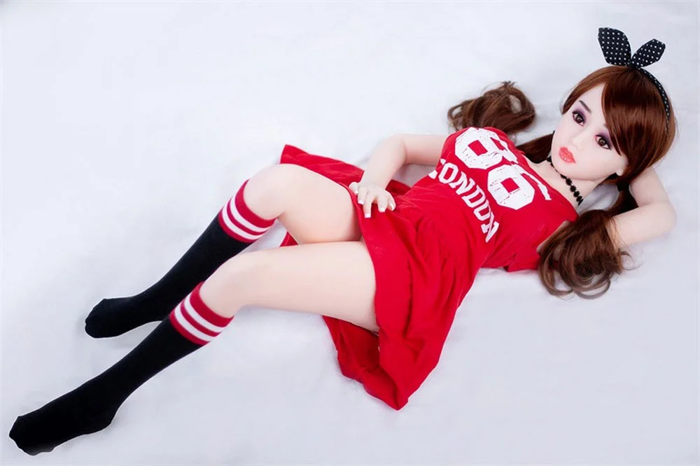 A mini sex doll lying on the ground with hands under the head
