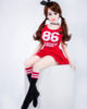 A mini sex doll sitting on a stool with hands on top