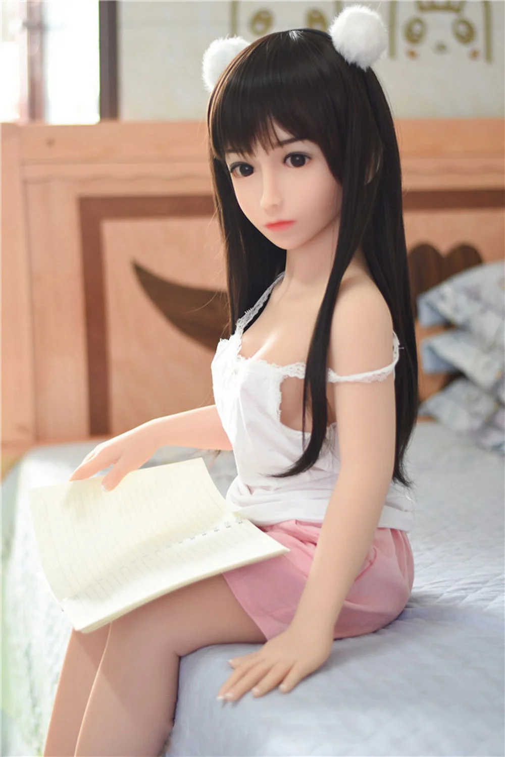 A sex doll wearing two white ball headbands
