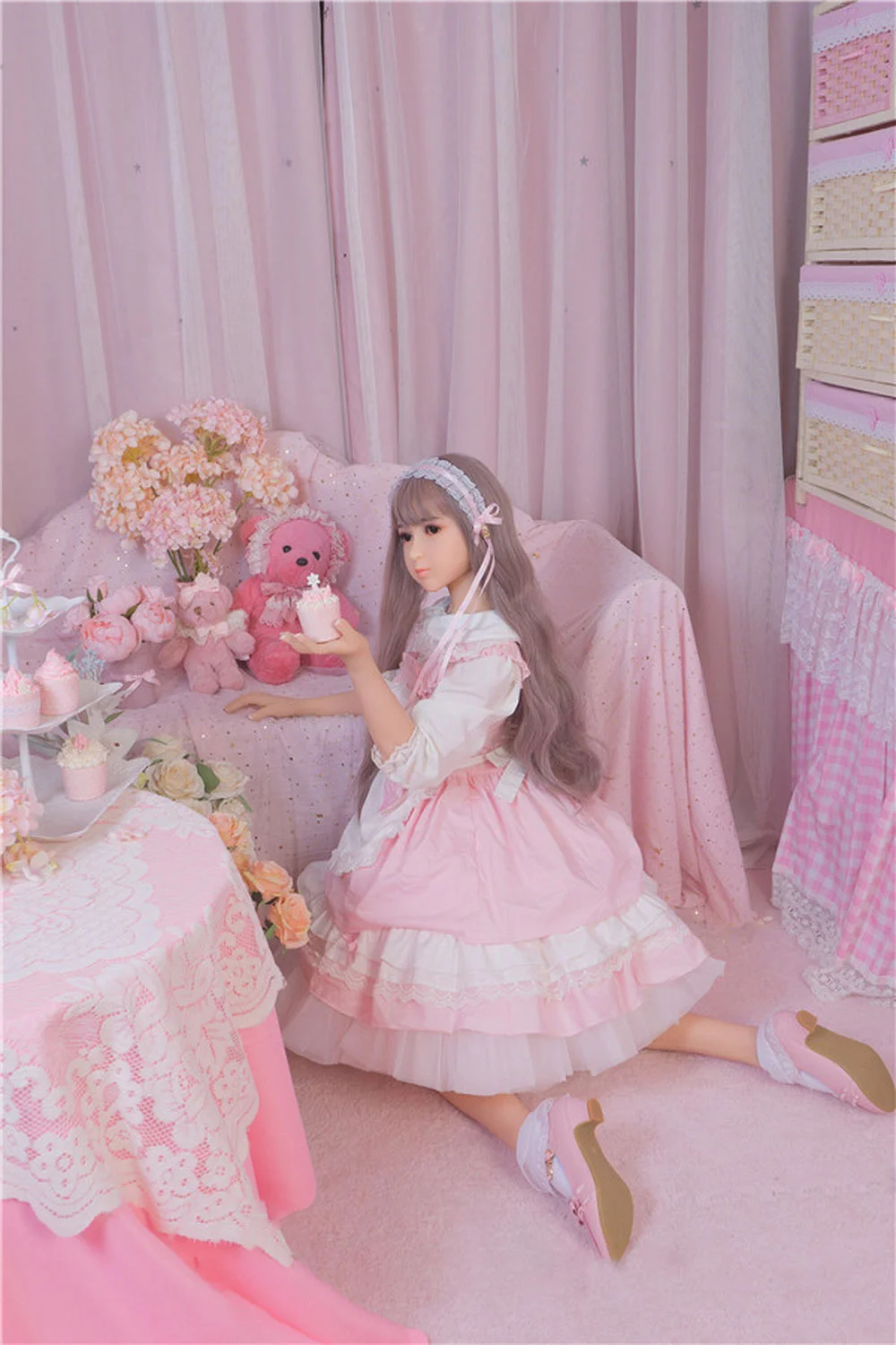 A sex doll with a lace headband on the head
