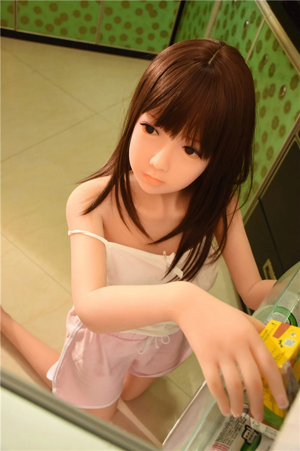 Hand holding sex doll in drink
