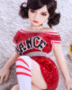 Mini sex doll lying on the ground with hands on top